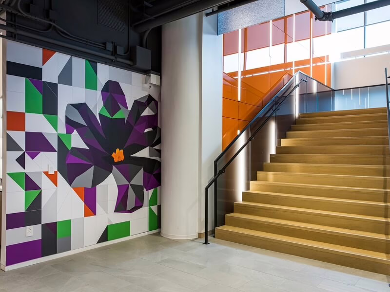 Violet-themed wall art beside staircase