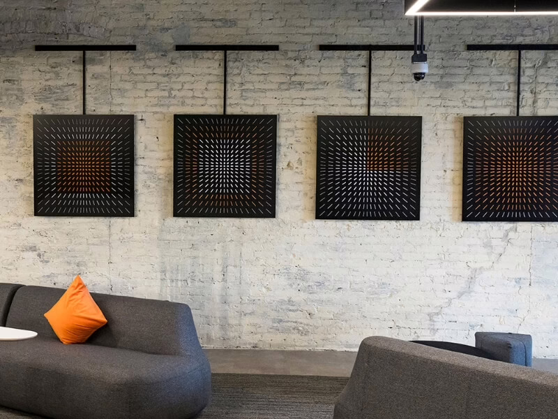 Four geometric graphics mounted on stone lounge wall